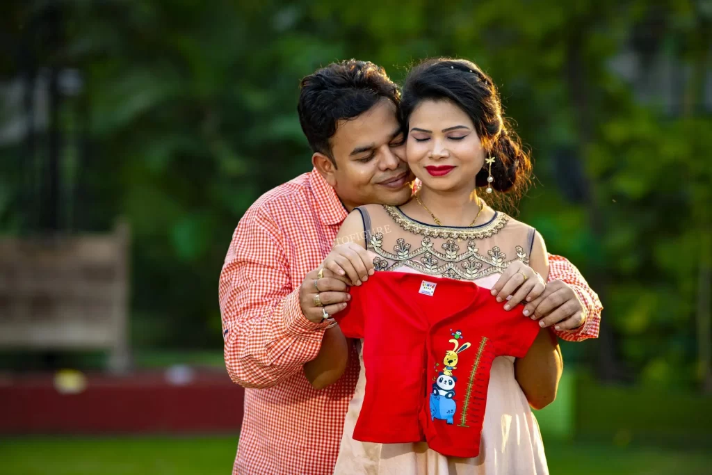 Pregnant belly with hands forming a heart