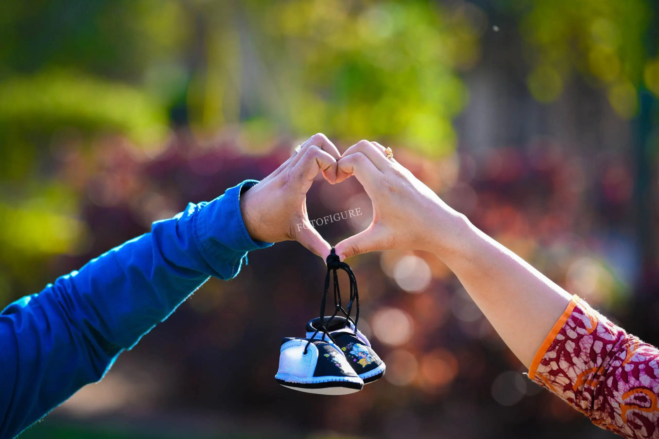 Expectant husband and wife embracing their growing family