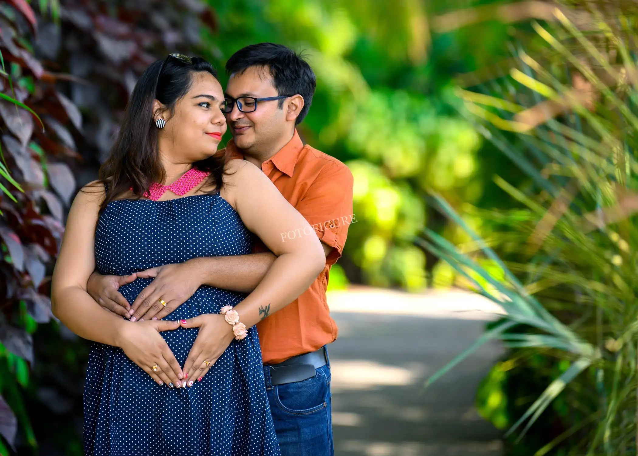 Joyful husband and wife with visible pregnancy bump