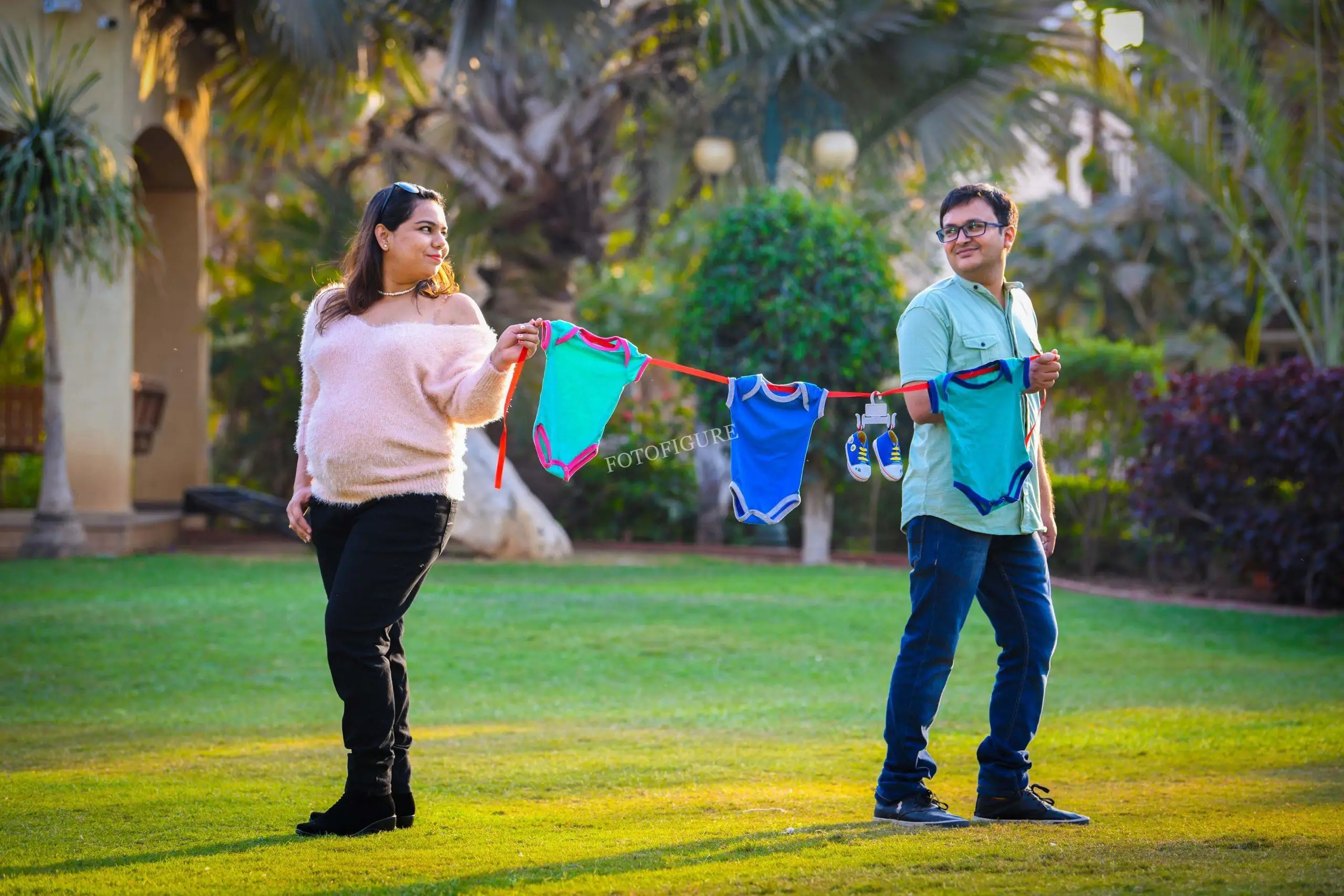 Happy couple celebrating pregnancy in photoshoot